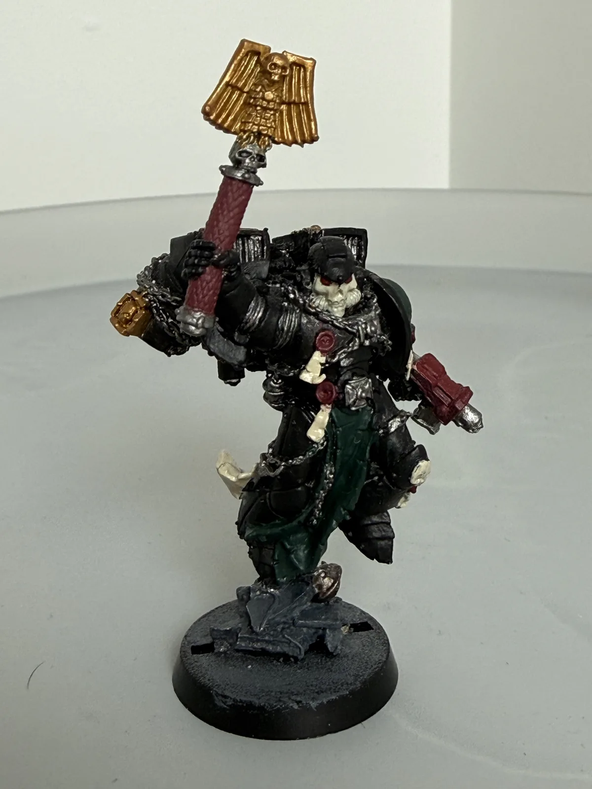 Commissioned Space Marine character in black armour with gold-topped banner