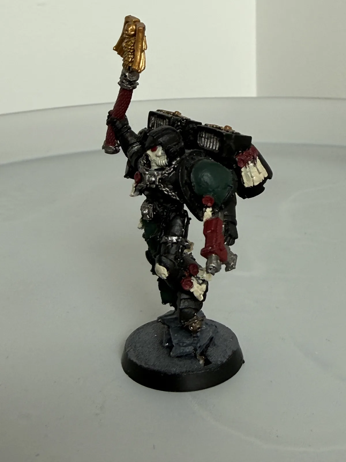 Commissioned Space Marine character in black armour, rear view showing backpack detail