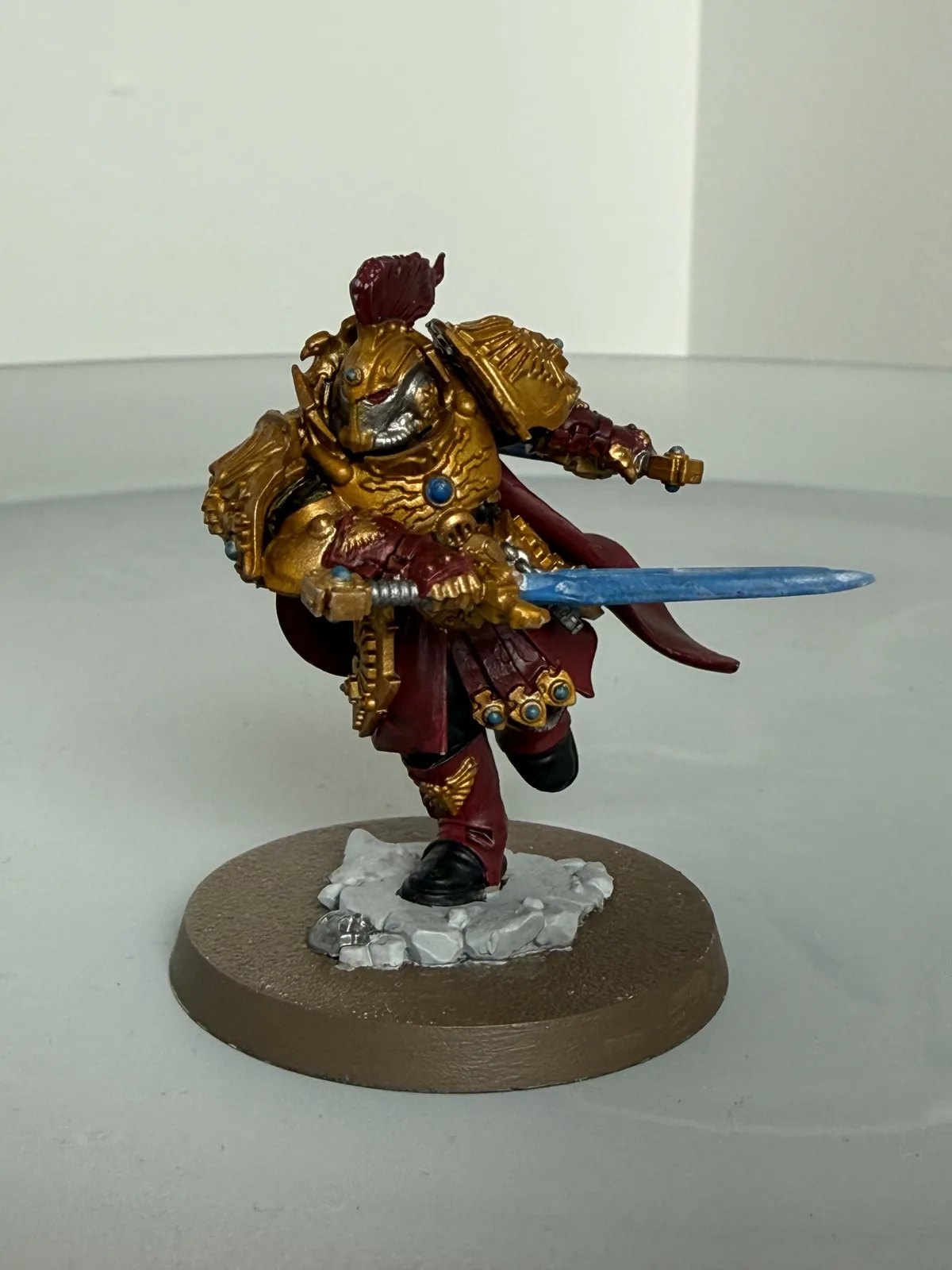 Commissioned Adeptus Custodes character in gold armour with red robes and power sword